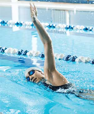 Swimmer performing a freestyle stroke in a lane pool